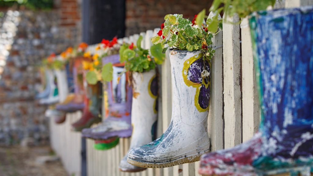 wellington boots on fence